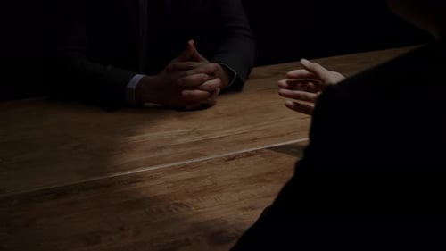 Money Exchange on Wooden Table During a Negotiation