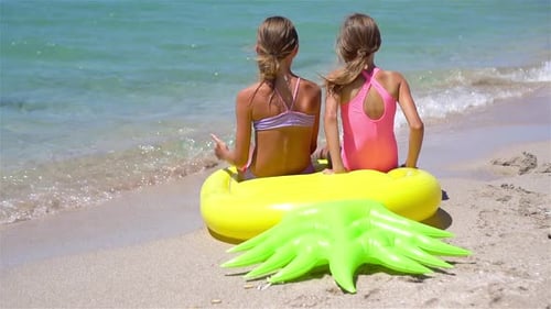 Little Girls Having Fun at Tropical Beach During Summer Vacation Playing Together