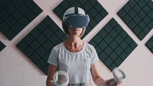 Woman Using Virtual Reality Headset and Controllers