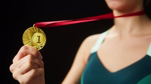 Woman Shows off First Place Gold Medal