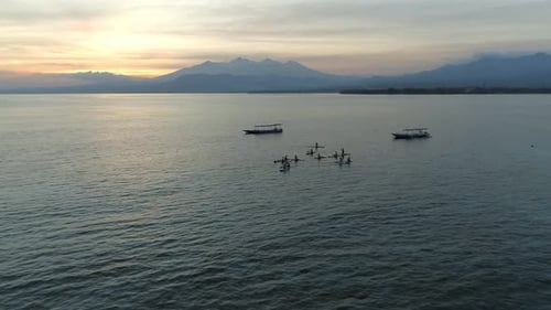Sunrise Yoga Class on Stand Up Paddle Boards in the Calm Ocean
