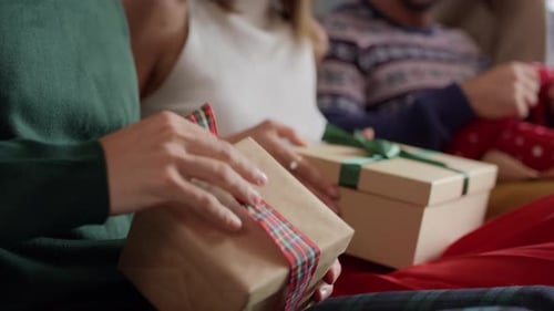 Friends Opening Christmas Presents Together at Home