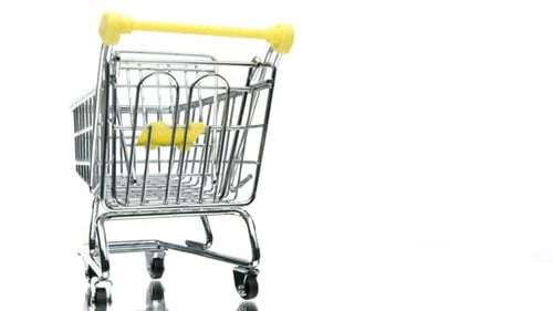 Empty Miniature Toy Supermarket Trolley Reflected in Glass Surface 360 Rotating