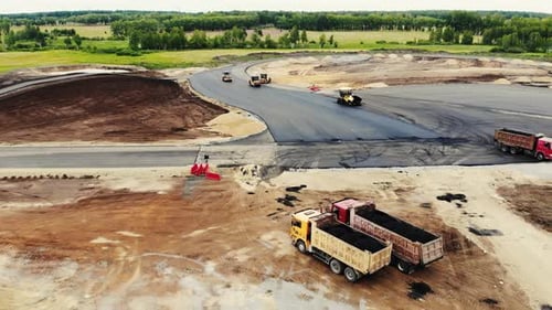 Aerial View of the Yellow Road Rollers That Lay Asphalt on the Testing Ground for Cars