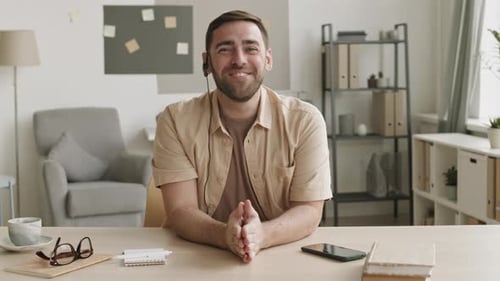 Man Talks During a Video Call with Headset