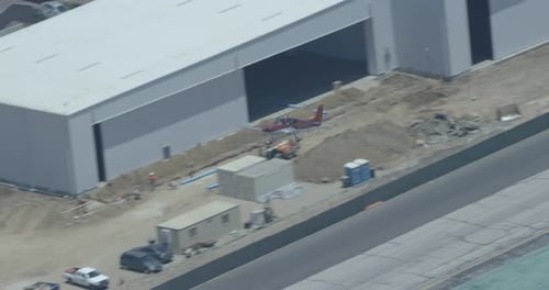 Foggy helicopter aerial of bay surrounded by mountains, overcast day