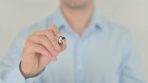 Man Writing Business Trends on Clear Surface