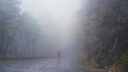 Happy Man, Tourist Walking on Misty Road with Outstretched Arms and Dancing
