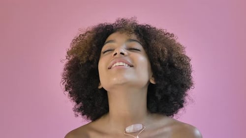 Woman Using Crystal Facial Roller for Skincare