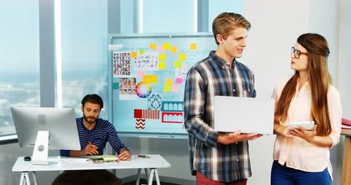 Team Brainstorming in Modern Office with Technology