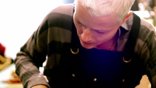 Craftsperson Cutting Leather at Workspace Desk