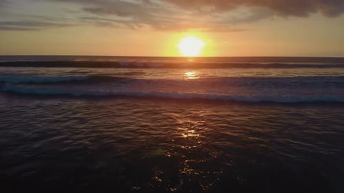 Flight at Sunset Overlooking the Indian Ocean in Bali Indonesia