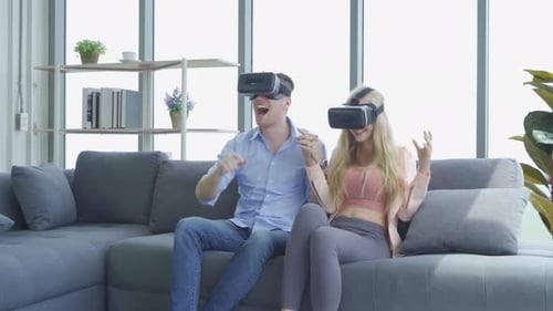 Enthusiastic Couple Using VR Headsets in Living Room