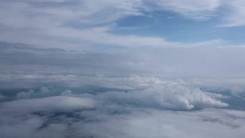 Aerial View of Fluffy Clouds Against Blue Sky
