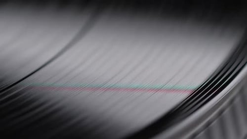 Rotating Vinyl Record in Dark Close-Up