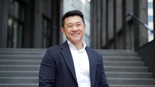 portrait young confident successful asian businessman looking at camera.