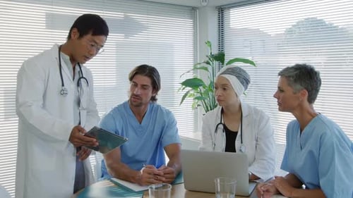 Medical Team Discussing Case in Modern Office