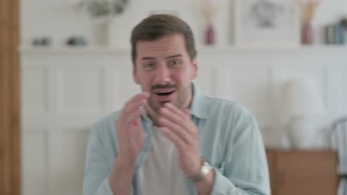 Man Displays Emotions in Indoor Setting