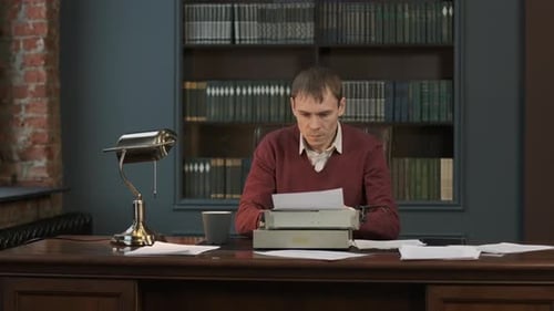 Man Typing on Vintage Typewriter in Office