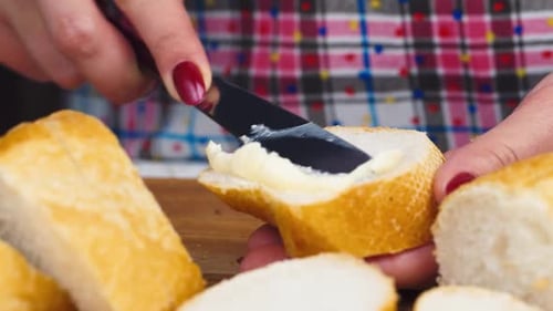 Spreading Butter on Baguette Slices for a Snack