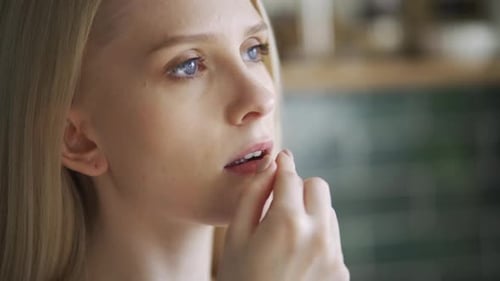 Woman Taking Pill and Drinking Glass of Water