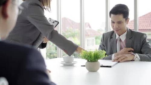 Professionals in Modern Office Discussing Documents