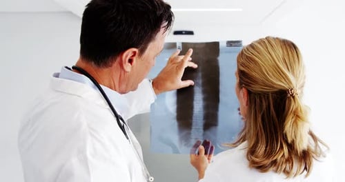 Doctors Reviewing Chest X-Ray in Hospital Setting