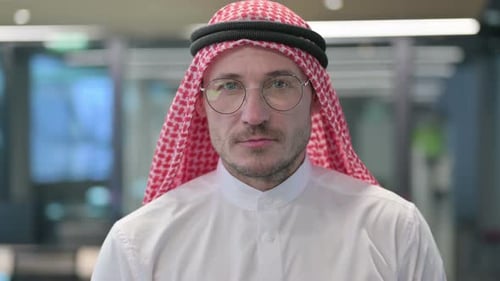 Man with Head Covering Looking Into Camera