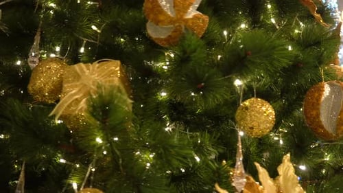 Festive Christmas Tree with Golden Ornaments and Lights