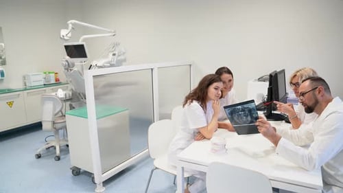 Medical Team Reviewing Dental X-Ray in Office