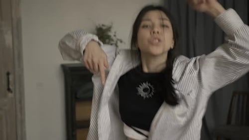 Woman Dances Energetically Indoors