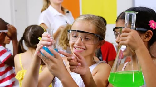 Children Examine Beakers in Science Classroom