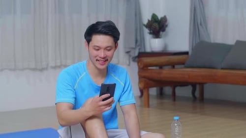 Young Adult Man Using Phone While Sitting