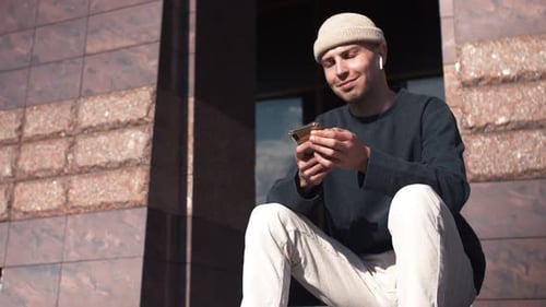 Young Adult Using Phone on Urban Steps