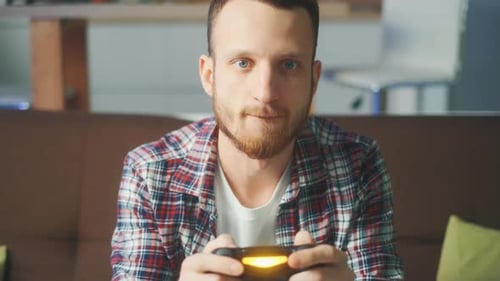 Young Man Playing Video Games Holding Controller