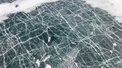 Hovercraft Gliding on Beautiful Frozen Ice Surface of Baikal Lake in Winter in Russia