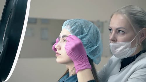 Beautician Grooming Woman's Eyebrows