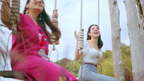 Young Women Enjoying Time on Rope Swings