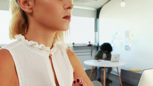 Female executives doing yoga in office