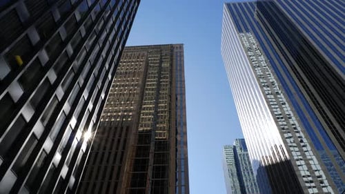 Tilting Up To Reveal Tall Downtown Office Buildings On Sunny Day 1