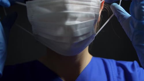 Healthcare Worker Putting on a Medical Face Mask