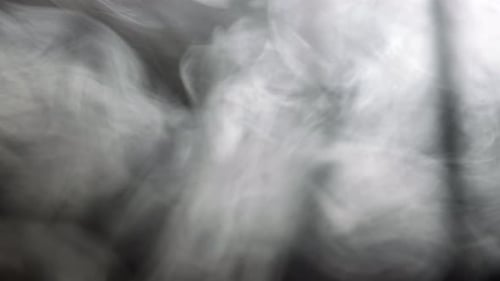 Abstract White Smoke Swirling on Black Background
