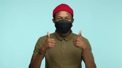 Adult Giving Thumbs Up While Wearing Face Mask