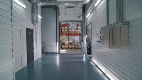 Worker Uses a Stacker in a Warehouse