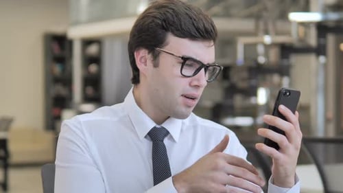 Happy Man Uses Smartphone, Celebrates Success