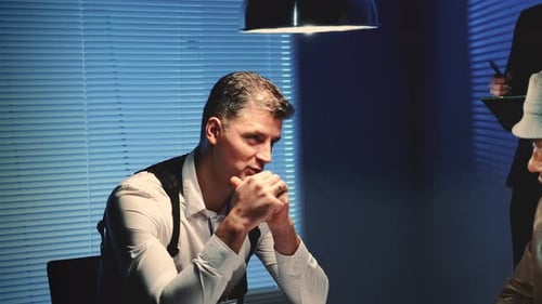 Close-up of Police Detective Is Threatened with a Weapon During Interview