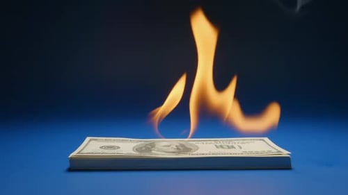 Heap Of Paper Money (US Dollar) Flaming on a Table