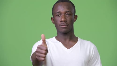 Young Adult Giving a Thumbs Up Gesture