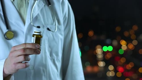 Doctor Holding Pill Bottle at Night