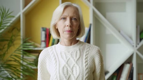 Senior Woman Portrait in Front of Bookshelf